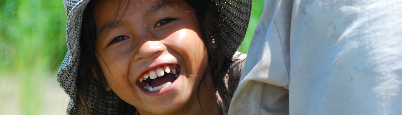 Header: Smiling Khmer girl in rice field